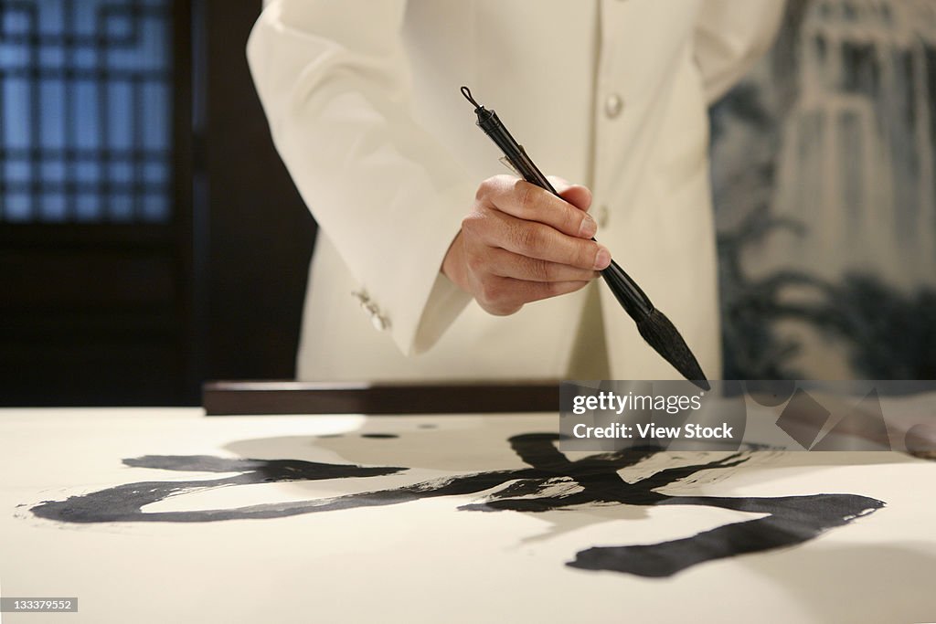 Chinese Man Practising Calligraphy