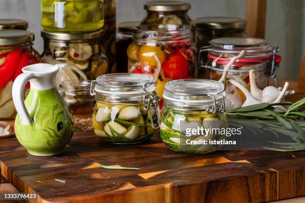 kitchen pantry. making preserved garlic in oil - confit stock pictures, royalty-free photos & images