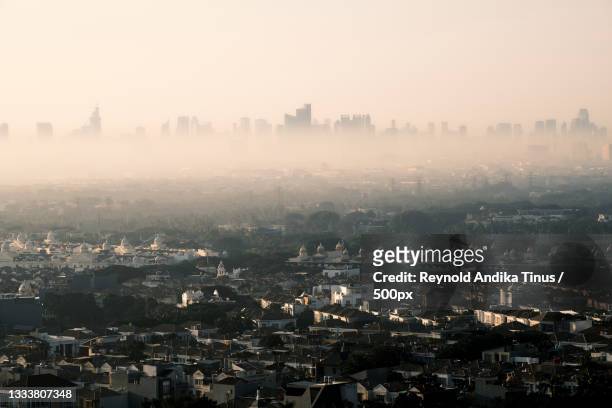 high angle view of city buildings against sky,jakarta,indonesia - jakarta stock pictures, royalty-free photos & images