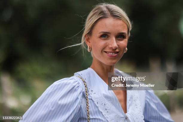Scarlett Gartmann wearing Miu Miu blue blouse and Chanel yellow leather bag on August 07, 2021 in Dusseldorf, Germany.