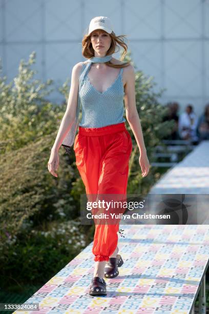 Model walks the runway at the GANNI show during the Copenhagen Fashion Week Spring/Summer 2022 on August 12, 2021 in Copenhagen, Denmark.