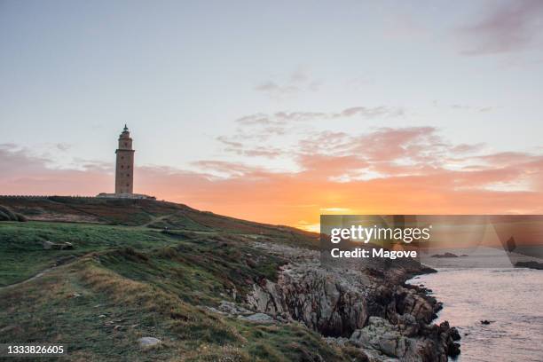 general view of the tower of hercules located in coruna - galicia - spain in a sunset - la coruña stockfoto's en -beelden