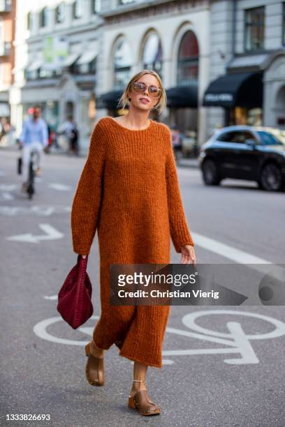 Hanna Stefanson seen wearing rust brown woolen dress outside By Malene Birger on August 11, 2021 in Copenhagen, Denmark.