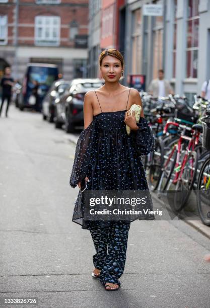 Guest is seen wearing dress outside By Malene Birger on August 11, 2021 in Copenhagen, Denmark.