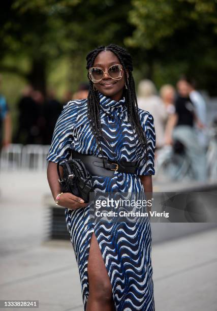 Lois Opoku seen wearing blue dress, belt outside Baum und Pferdgarten on August 11, 2021 in Copenhagen, Denmark.