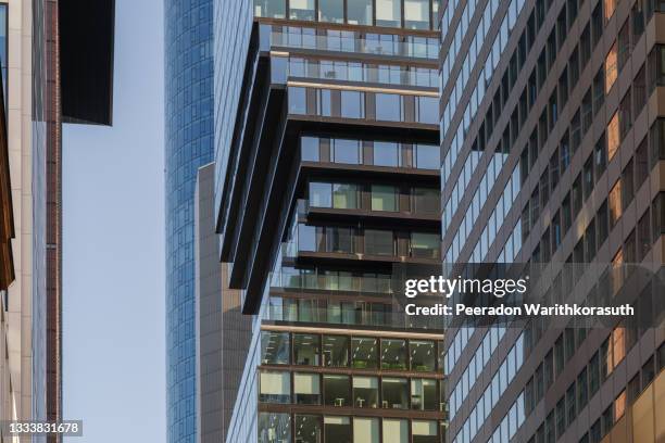 exterior architectural detail modern facade of high-rise office buildings. abstract urban metropolis background. - cladding stock pictures, royalty-free photos & images