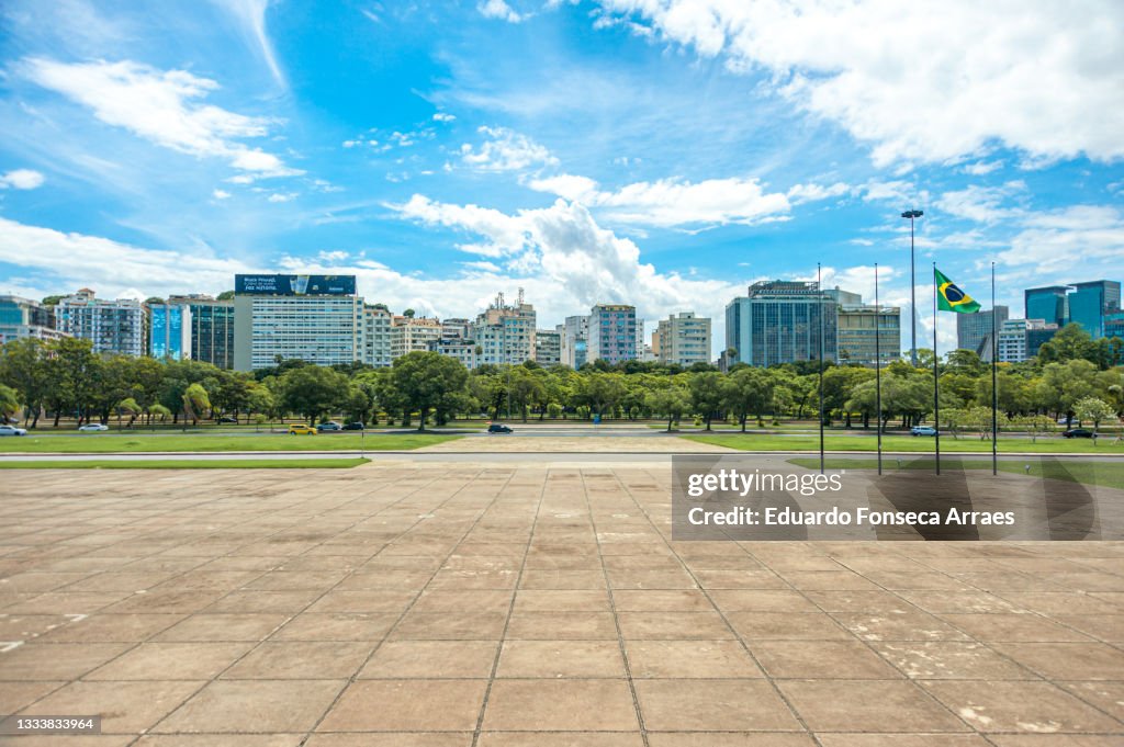 View of downtown Rio with its skyscrapers, a public park and the Brazilian national flag