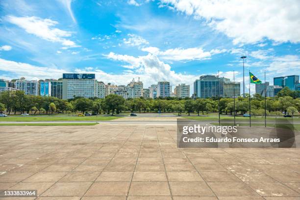 view of downtown rio with its skyscrapers, a public park and the brazilian national flag - rio de janeiro street stock pictures, royalty-free photos & images