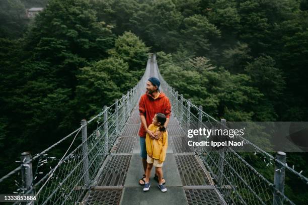 father and young daughter enjoying view from bridge, iya valley - iya valley stock pictures, royalty-free photos & images