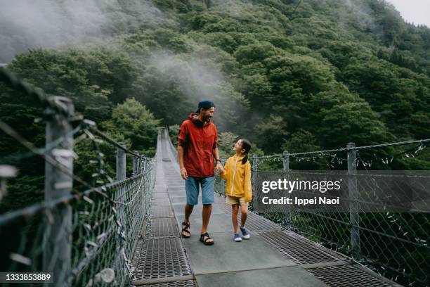 father and daughter walking together on bridge, iya valley - bridge fog stock pictures, royalty-free photos & images