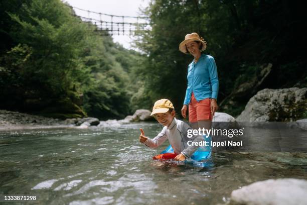 mother and child playing in clear river water, iya valley, japan - tokushima prefecture stock pictures, royalty-free photos & images