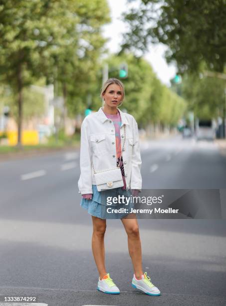 Scarlett Gartmann wearing Loewe colorful sweater, Miu Miu beige jacket, Chanel white leather bag, Free People denim mini skirt and Chanel white...