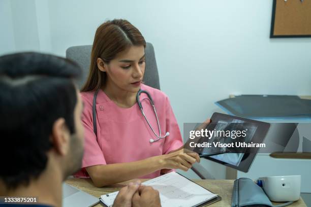 doctor explaining the results of scan lung on digital tablet screen to patient. - tuberculosis stock pictures, royalty-free photos & images