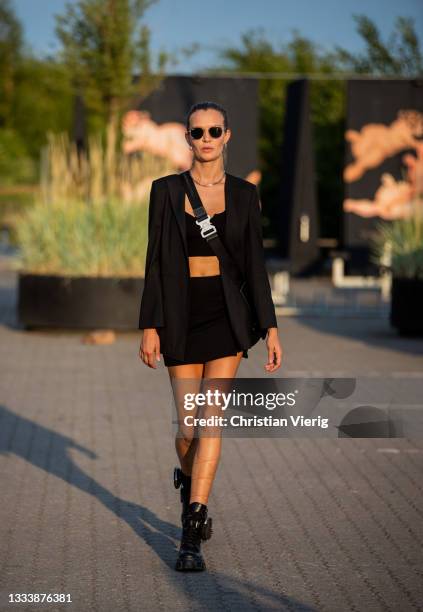 Josephine Skriver is seen wearing cropped top, black, bag boots outside Rotate on August 12, 2021 in Copenhagen, Denmark.