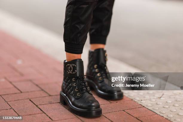 Scarlett Gartmann wearing Chanel black boots and Zara black pants on August 07, 2021 in Dusseldorf, Germany.