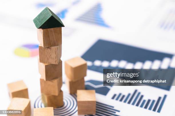 engineer playing a blocks wood tower game (jenga) on blueprint or architectural project,growth concept - financial failure bildbanksfoton och bilder