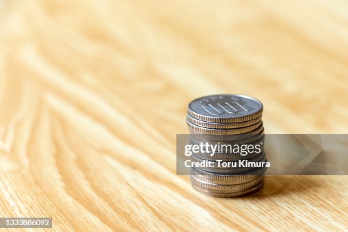 Japanese 100-yen coins piled up on the desk Japanese 100-yen coins piled up on the desk