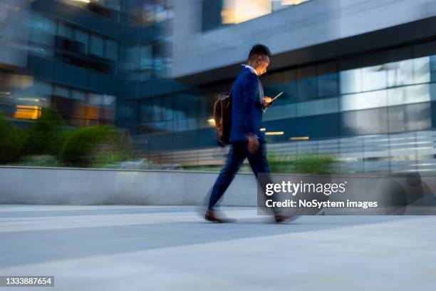 businessman rushing to the office, using phone - after work stock pictures, royalty-free photos & images