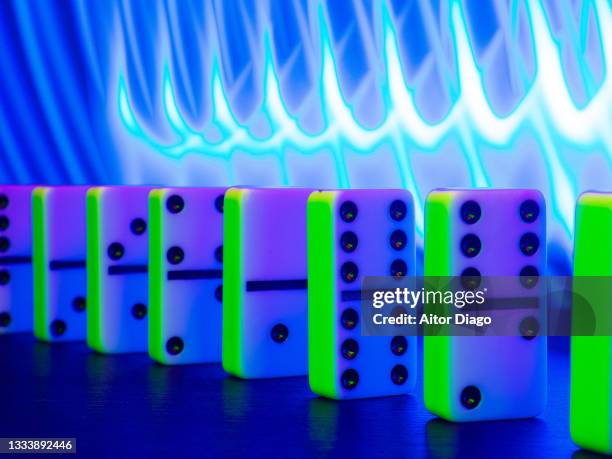 a domino with a modern background formed with blue curved lights. - second chance stock pictures, royalty-free photos & images