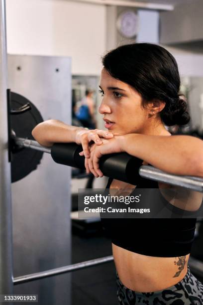 young woman resting after a workout in a gym - gym resting stock pictures, royalty-free photos & images