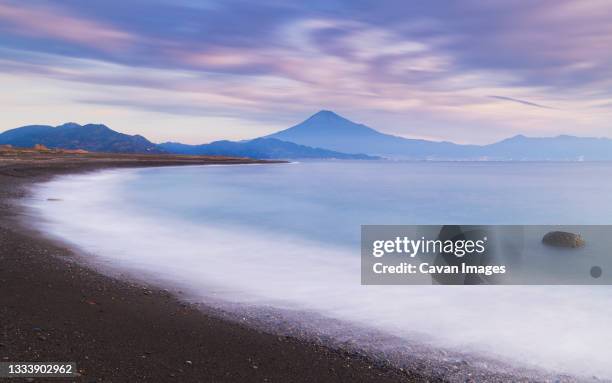 sunrise view of mount fuji from the beach, shizuoka prefecture, japan - cinematic sunrise stock pictures, royalty-free photos & images