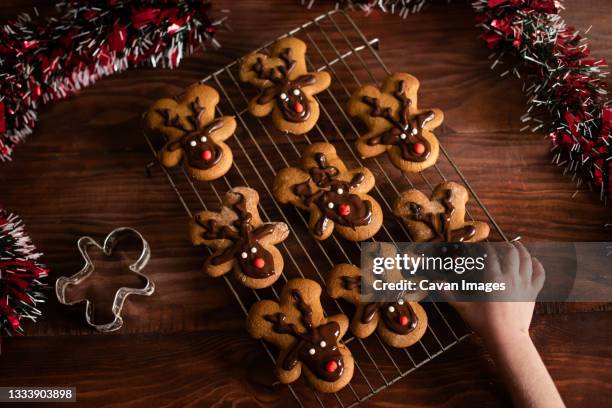 christmas holiday festive reindeer cookies homemade with little hand - biscuit france stock pictures, royalty-free photos & images