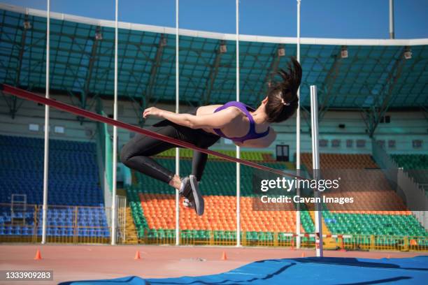 sportswoman doing high jump exercise - professional sportsperson ストックフォトと画像