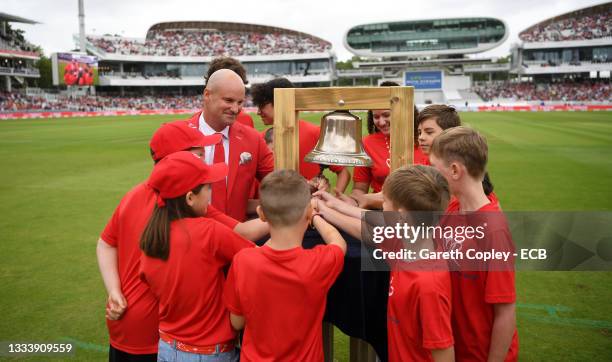 Former England captain Andrew Strauss rings the five minute bell alongside families with have been supported by the Ruth Strauss Foundation ahead of...