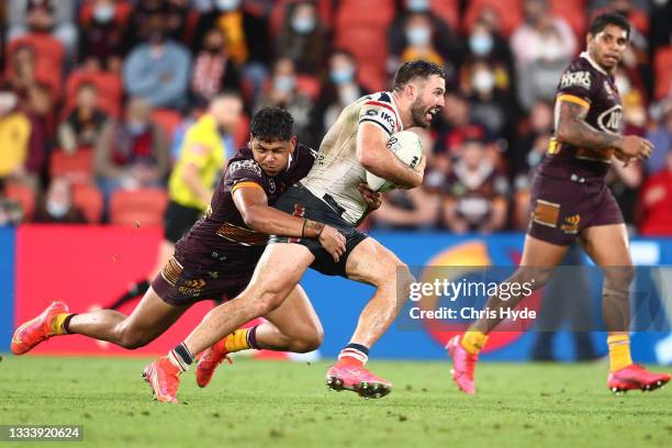 James Tedesco of the Roosters makes a break during the round 22 NRL match between the Brisbane Broncos and the Sydney Roosters at Suncorp Stadium, on...