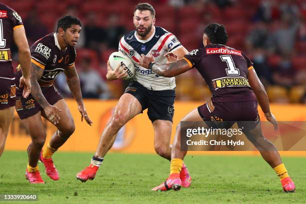 James Tedesco of the Roosters makes a break during the round 22 NRL match between the Brisbane Broncos and the Sydney Roosters at Suncorp Stadium, on...