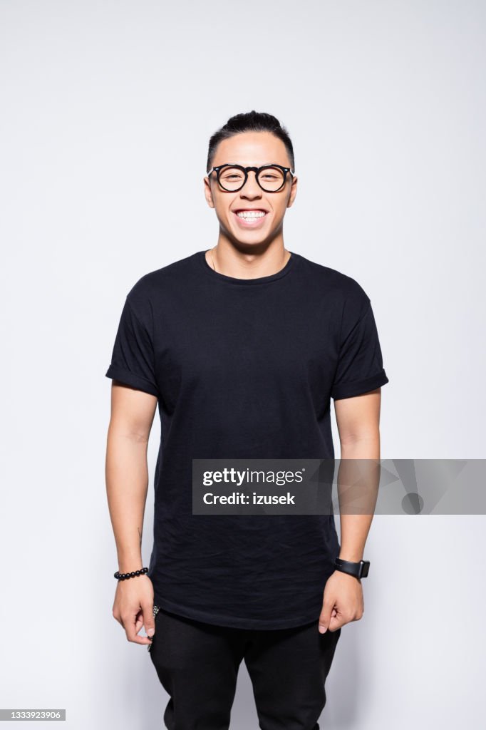 Cheerful asian young man in black clothes
