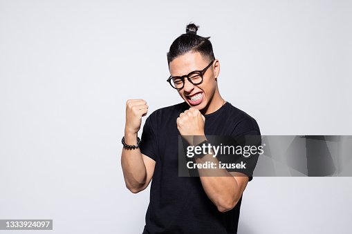 Excited asian young man in black clothes Excited asian young man in black clothes