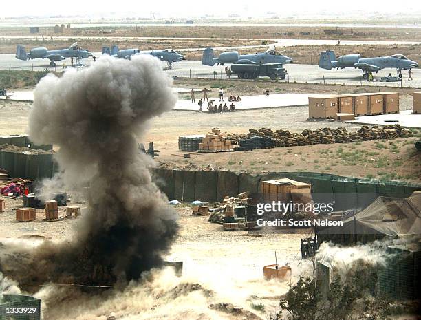 Soldiers on the flight line watch as a soviet made rocket propelled grenade is detonated in a controlled explosion by members of the US Army 764th...