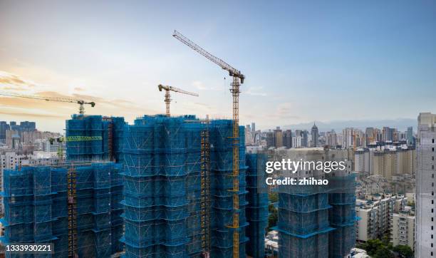 construction site of high-rise residential area using crane - china infrastructure stock pictures, royalty-free photos & images