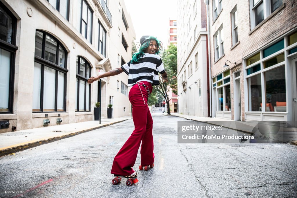 Young woman rollerskating in urban area