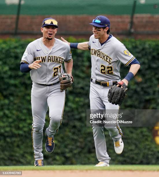 Willy Adames and Christian Yelich of the Milwaukee Brewers reacts after the fourth inning against the Chicago Cubs at Wrigley Field on August 12,...