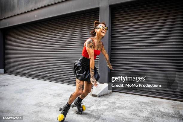 young woman rollerskating in urban area - colour street dance stock pictures, royalty-free photos & images