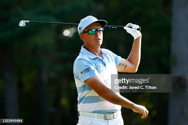Rickie Fowler of the United States watches his shot on the 12th tee during the second round of the Wyndham Championship at Sedgefield Country Club on...