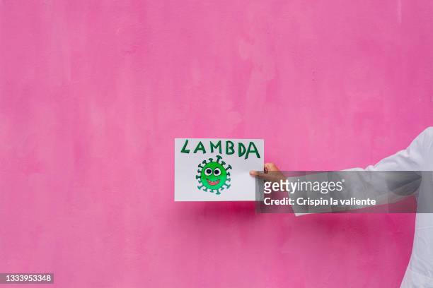 hand holding a sign with "lambda"  (variant covid) - lambda phage stock pictures, royalty-free photos & images