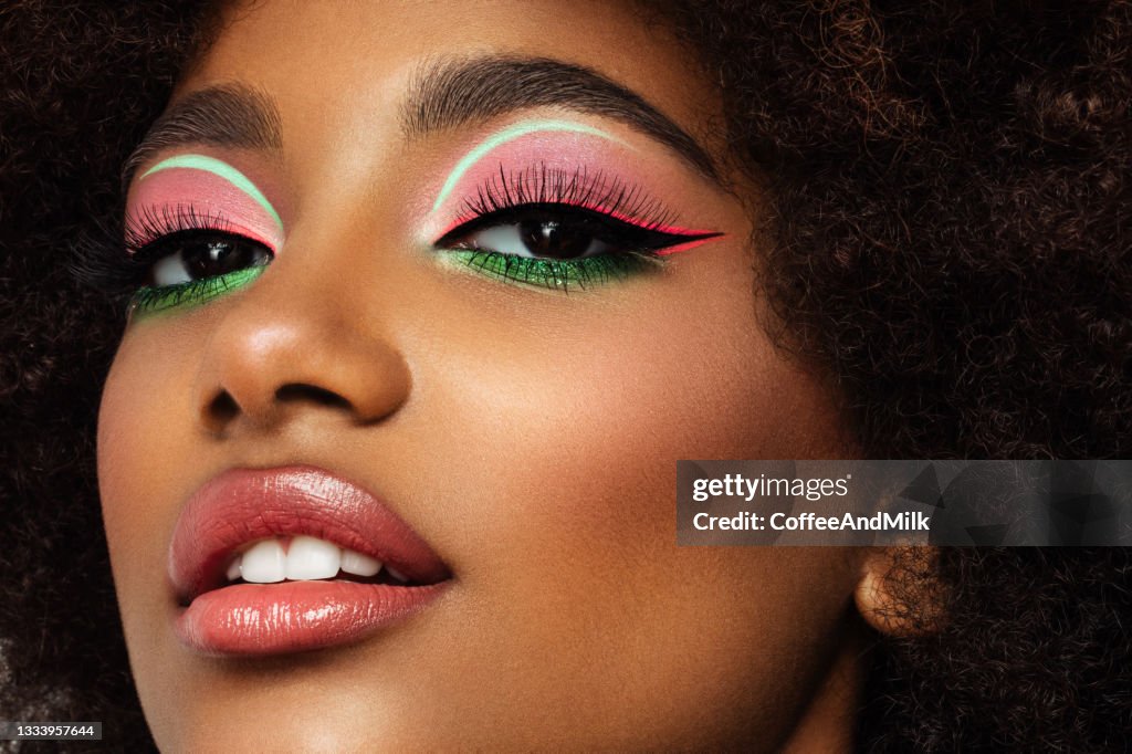 Portrait of young afro woman with bright make-up