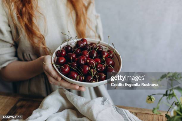 a plate of cherries - cherry on top stock-fotos und bilder