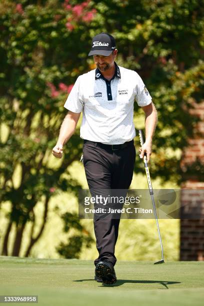 Webb Simpson of the United States celebrates a putt for birdie on the ninth green during the second round of the Wyndham Championship at Sedgefield...