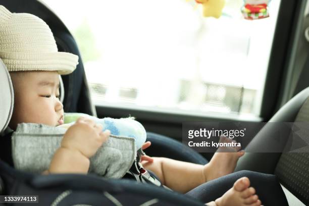 asian baby boy in the car - baby car seat stock pictures, royalty-free photos & images