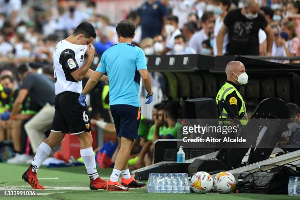 Hugo Guillamon of Valencia reacts as he leaves the pitch after being shown a red card during the La Liga Santader match between Valencia CF and...