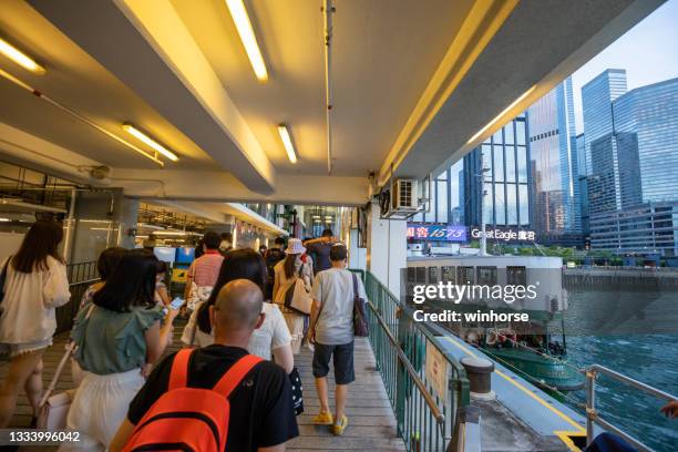 star ferry at the wanchai ferry pier in hong kong - commuter ferry stock pictures, royalty-free photos & images