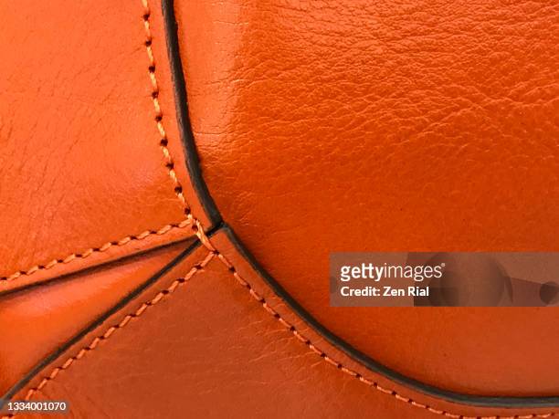 decorative details on an orange handbag - leather bag stock pictures, royalty-free photos & images