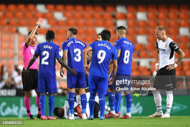 Match Referee, Jesus Gil Manzano shows a red card to Erick Cabaco of Getafe during the La Liga Santader match between Valencia CF and Getafe CF at...