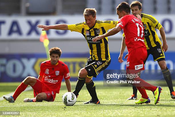 Ben Sigmund of the Wellington Phoenix is put under pressure from Iain Ramsay of Adelaide United during the round seven A-League match between the...