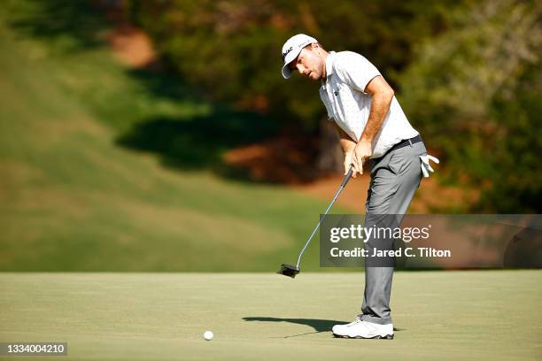 Russell Henley of the United States putts on the 18th green during the second round of the Wyndham Championship at Sedgefield Country Club on August...