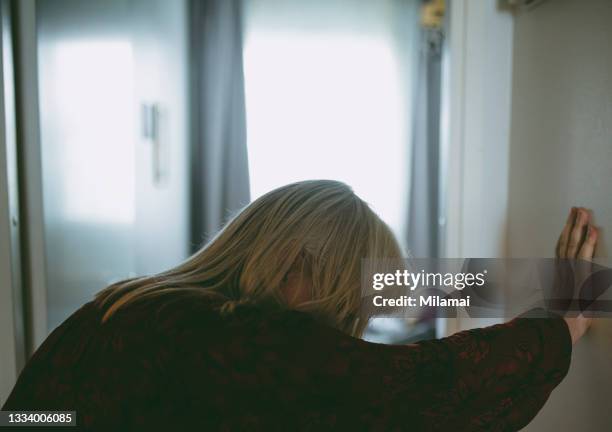 elderly female suffering dizziness and fatigue at home - heart attack stockfoto's en -beelden